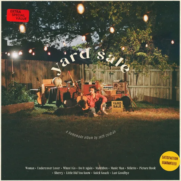 Yard Sale cover: Seth Celdrán on the grass of a back yard at dusk, among his guitars, amps and tape machines, under string lights